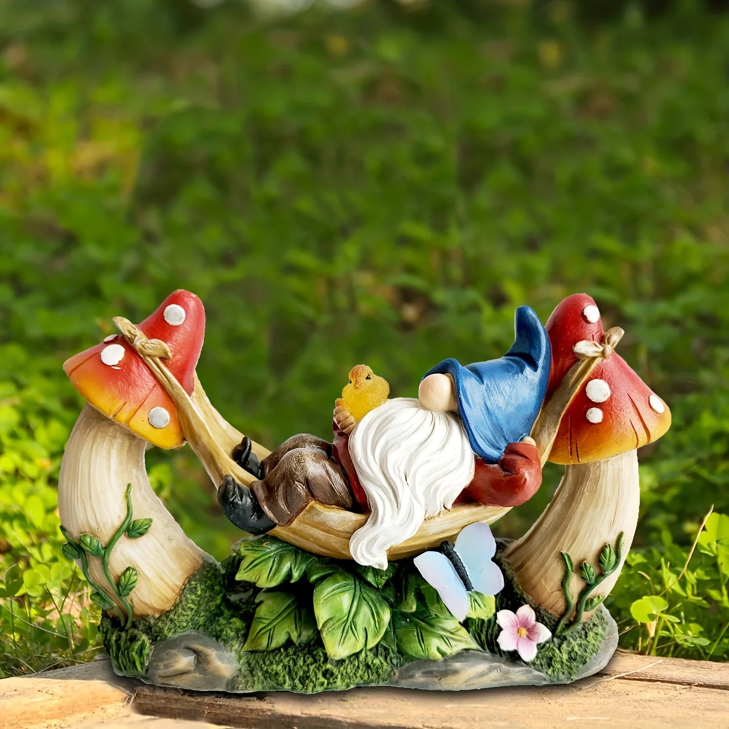 Solar Gnome Figurine Lying on Hammock with Bird and Mushroom